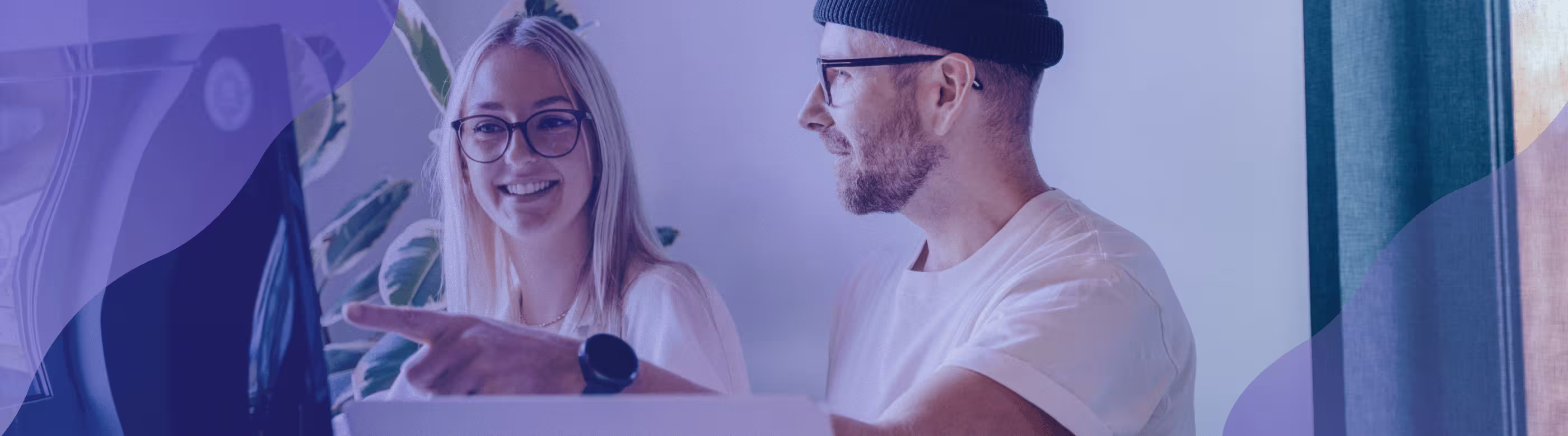 Two people looking at a monitor